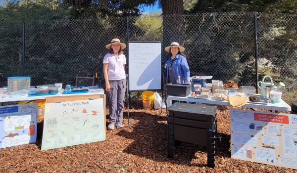 compost workshop instructors with their many instructional materials