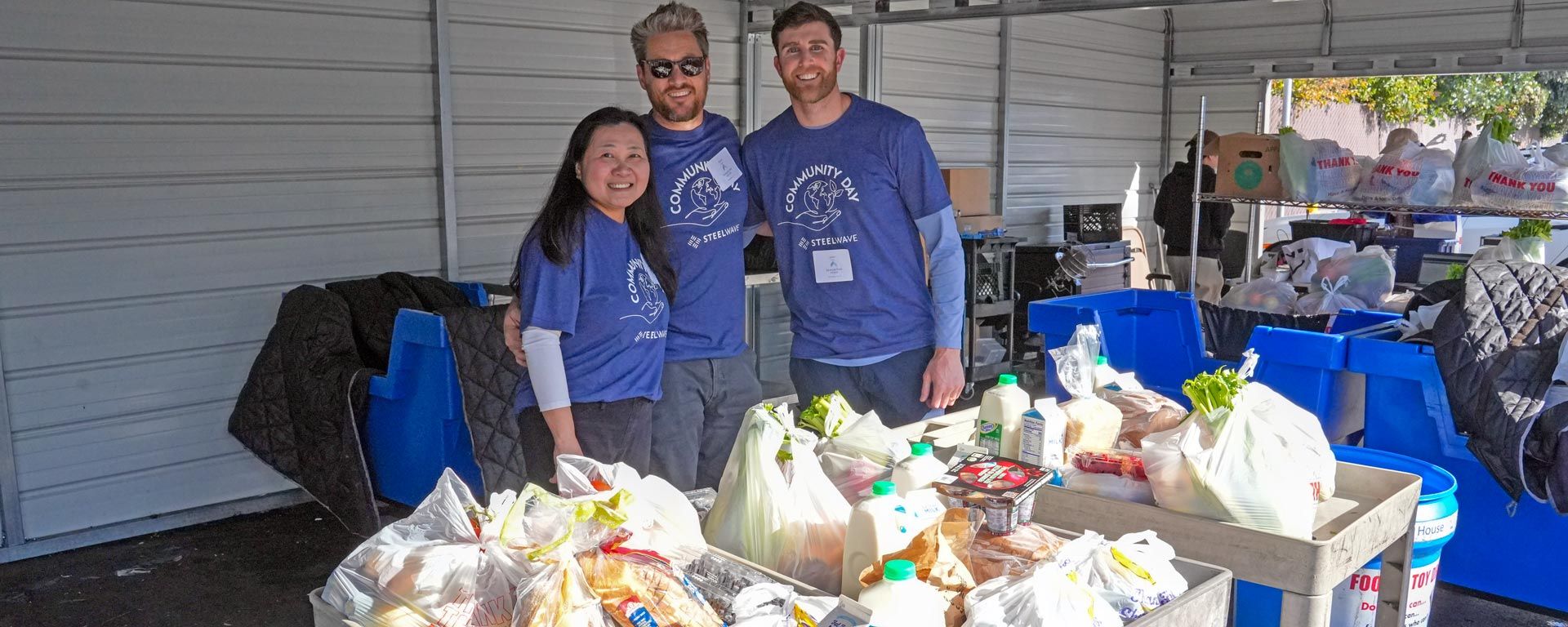 volunteers working at a food pantry with donated food