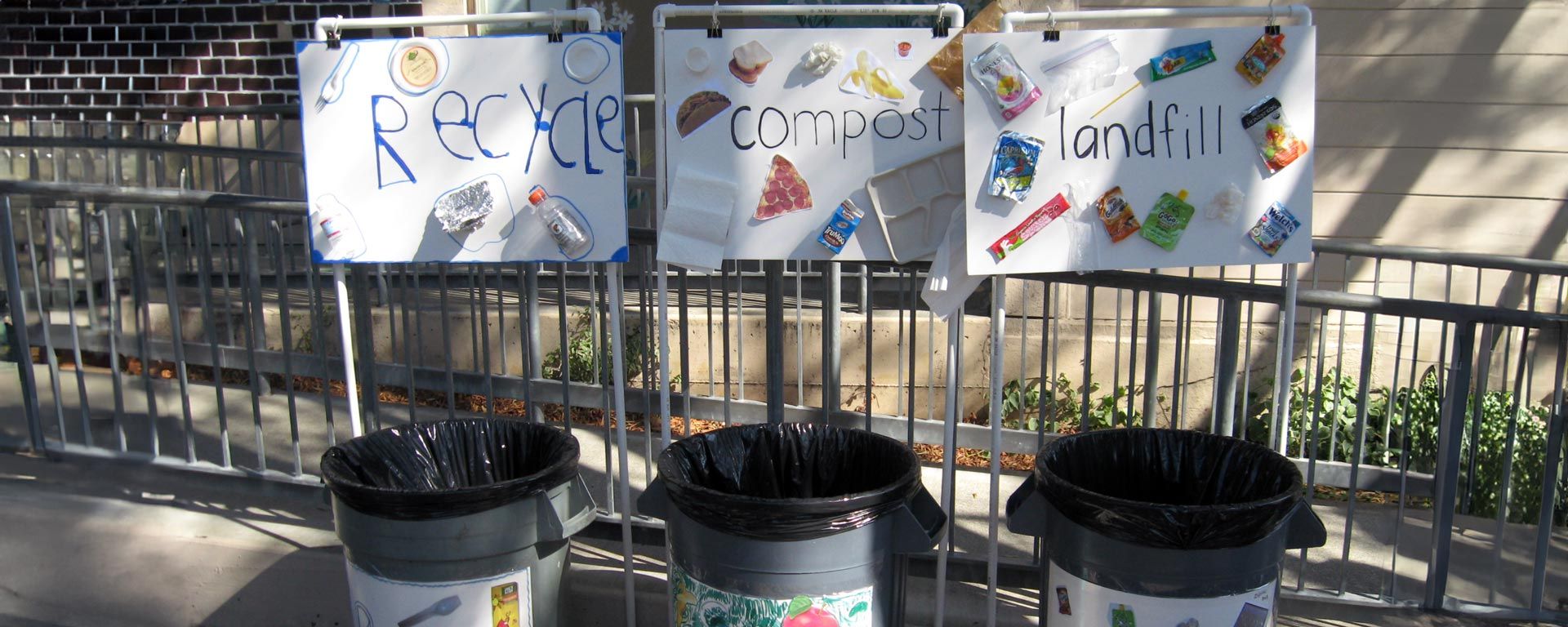 elementary school outdoor waste station with bins for recycling, compost and landfill