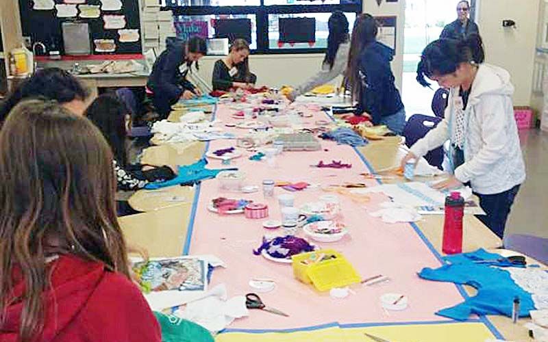 students making reusable bags