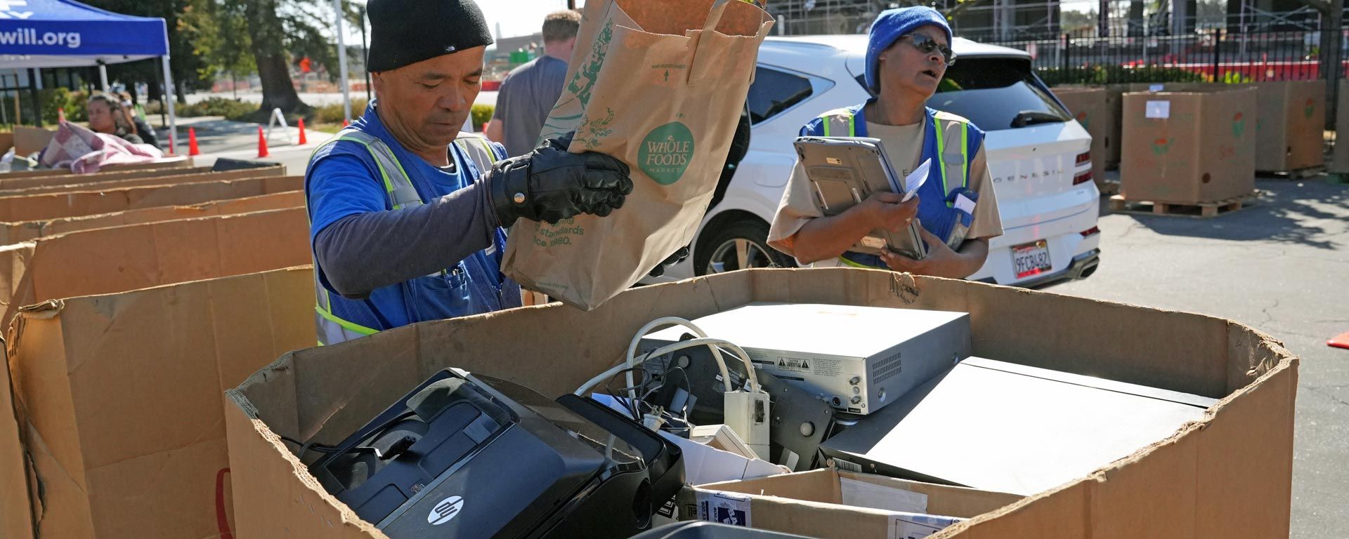 workers sorting electronics for recycling